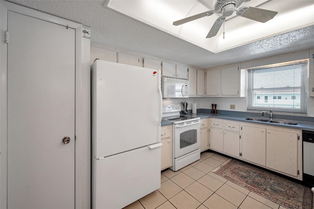 8 Glencoe Pl Unit 305, Dunedin, FL 34698 - kitchen with white appliances, a sink, a textured ceiling, light tile patterned floors, and a ceiling fan