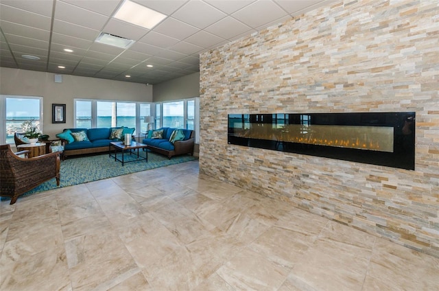 8 Glencoe Pl Unit 305, Dunedin, FL 34698 - living room with a glass covered fireplace and a drop ceiling