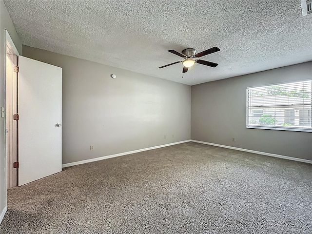 carpeted spare room with a ceiling fan, a textured ceiling, and baseboards