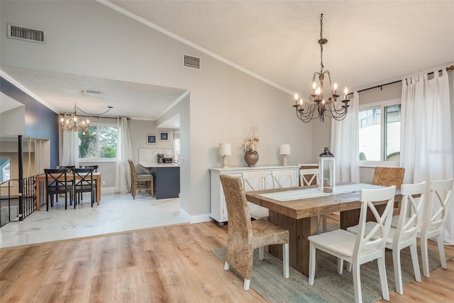 8240 144th Ln, Seminole, FL 33776 - dining room with a chandelier, crown molding, light wood-style floors, vaulted ceiling, and baseboards
