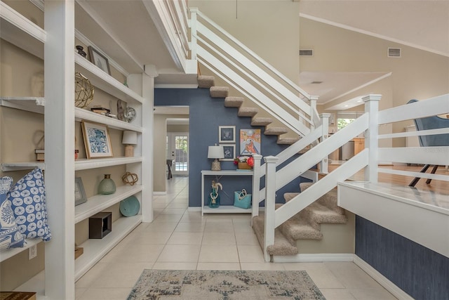 8240 144th Ln, Seminole, FL 33776 - staircase with baseboards, tile patterned floors, built in features, crown molding, and a high ceiling
