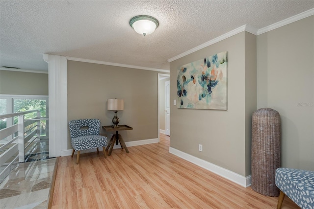 8240 144th Ln, Seminole, FL 33776 - sitting room with a textured ceiling, light wood-style floors, crown molding, and baseboards