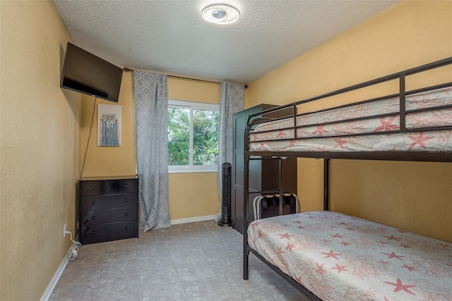 8240 144th Ln, Seminole, FL 33776 - bedroom featuring a textured ceiling and baseboards