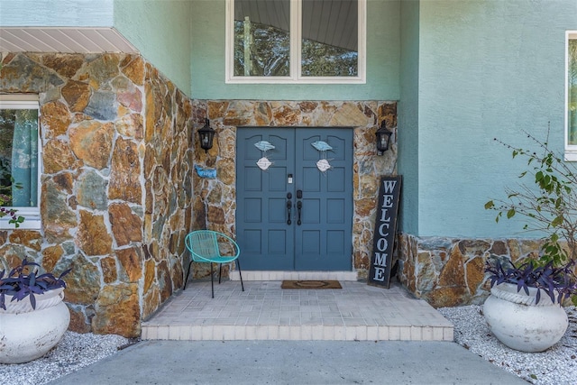 8240 144th Ln, Seminole, FL 33776 - entrance to property featuring stone siding and stucco siding