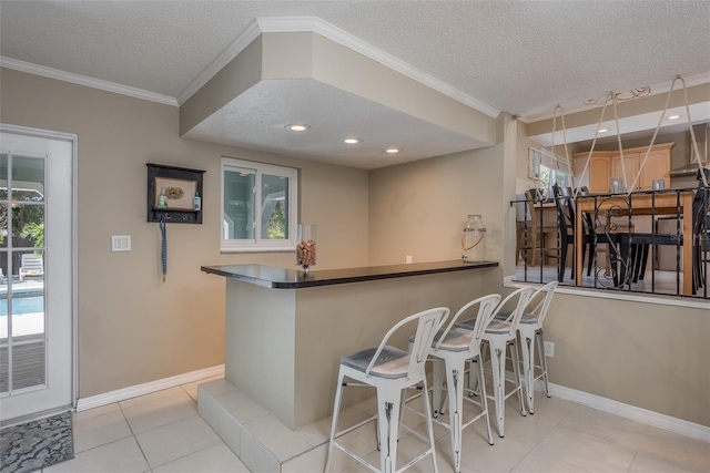 8240 144th Ln, Seminole, FL 33776 - kitchen with a textured ceiling, healthy amount of natural light, light tile patterned flooring, crown molding, and baseboards