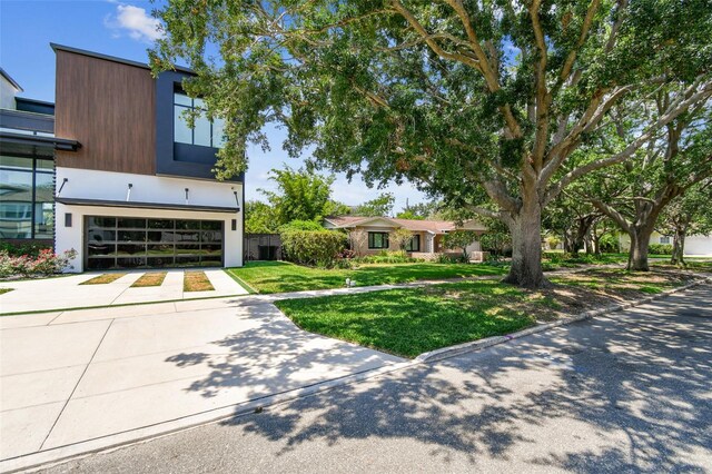 750 Alda Way NE, Saint Petersburg, FL 33704 - view of front facade with an attached garage, concrete driveway, and a front lawn