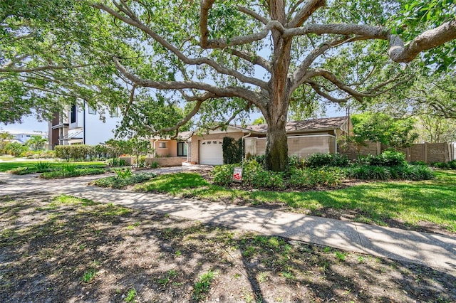 750 Alda Way NE, Saint Petersburg, FL 33704 - view of front facade with an attached garage and fence
