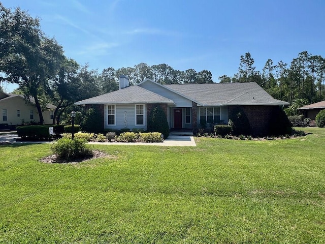 2528 Deerbrook Dr, Lakeland, FL 33811 - single story home featuring a front lawn and a chimney