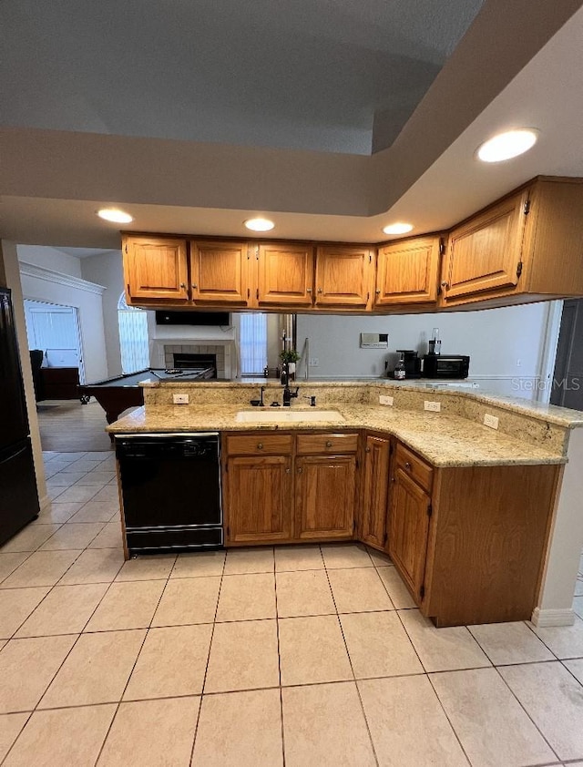 2528 Deerbrook Dr, Lakeland, FL 33811 - kitchen with black appliances, a sink, light stone counters, light tile patterned flooring, and recessed lighting