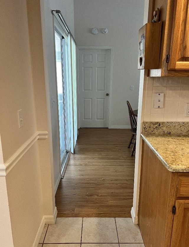 2528 Deerbrook Dr, Lakeland, FL 33811 - hallway with baseboards, plenty of natural light, and light tile patterned flooring