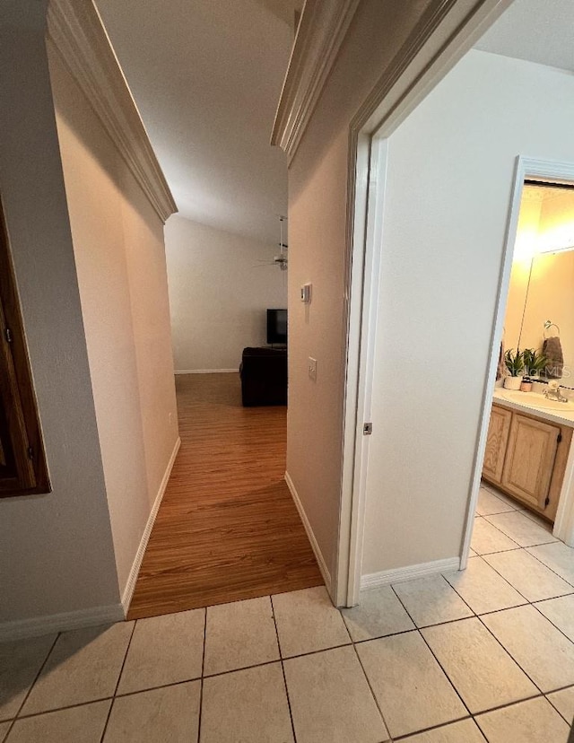 2528 Deerbrook Dr, Lakeland, FL 33811 - hallway with light tile patterned floors, ornamental molding, and baseboards