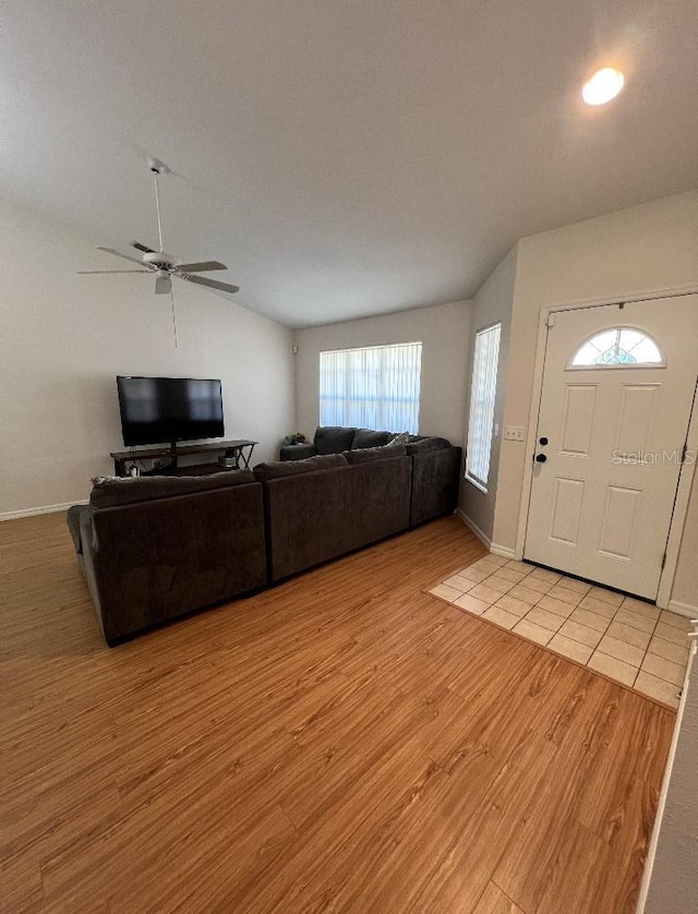 2528 Deerbrook Dr, Lakeland, FL 33811 - living area featuring light wood finished floors, a ceiling fan, lofted ceiling, and baseboards