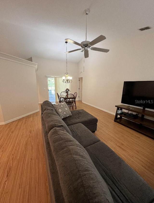 2528 Deerbrook Dr, Lakeland, FL 33811 - living room featuring baseboards, wood finished floors, ceiling fan, lofted ceiling, and a chandelier