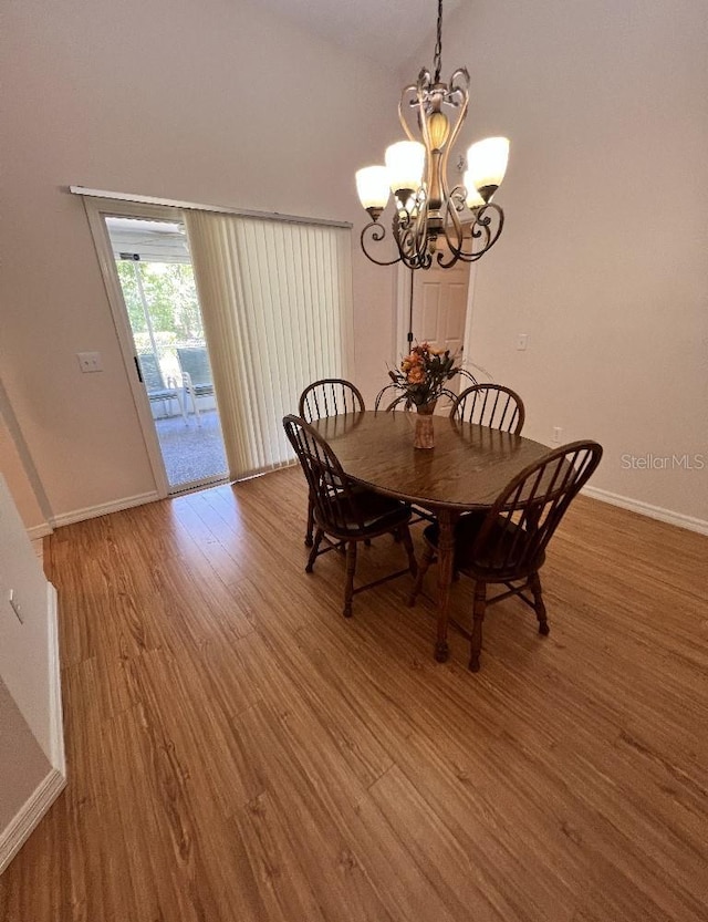 2528 Deerbrook Dr, Lakeland, FL 33811 - dining area featuring light wood-style flooring, a chandelier, and baseboards
