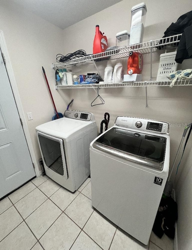2528 Deerbrook Dr, Lakeland, FL 33811 - washroom featuring washing machine and clothes dryer and light tile patterned floors