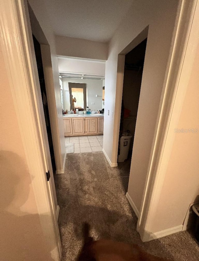 2528 Deerbrook Dr, Lakeland, FL 33811 - hallway with light carpet, light tile patterned floors, and baseboards
