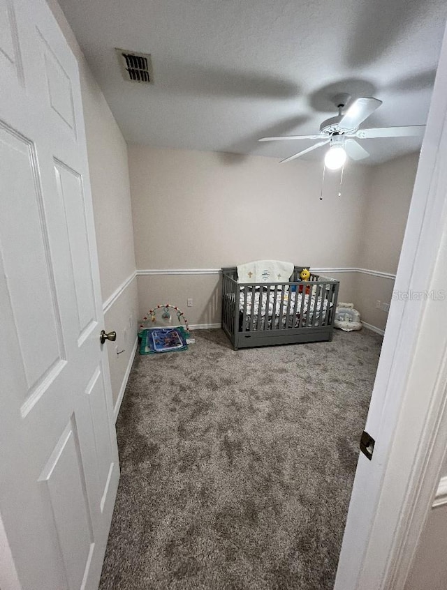 2528 Deerbrook Dr, Lakeland, FL 33811 - bedroom with carpet floors, a crib, baseboards, and ceiling fan