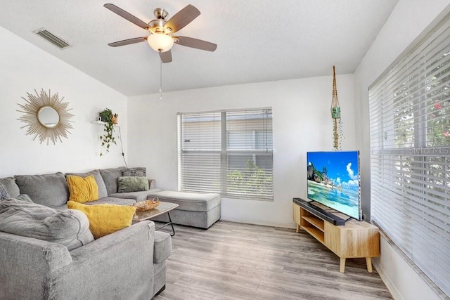 13523 Prestwick Dr, Riverview, FL 33579 - living room featuring ceiling fan, light wood finished floors, lofted ceiling, and a textured ceiling