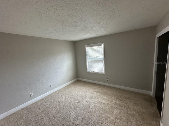 2557 Cedar Cypress Ct, Tampa, FL 33618 - unfurnished bedroom featuring light carpet and a textured ceiling