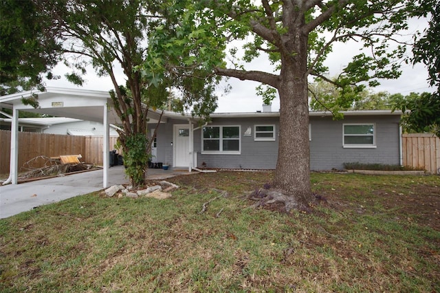 view of front of property with a carport and driveway