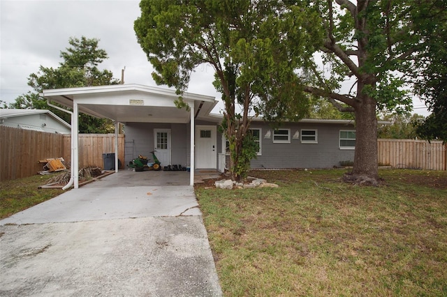view of front of property with concrete driveway and a carport