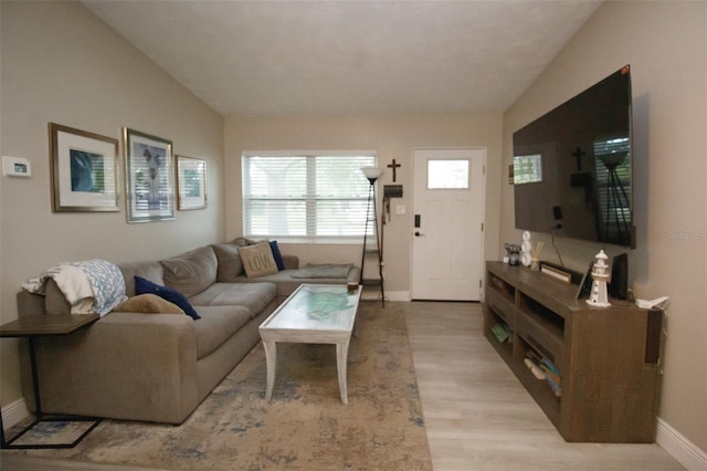 living area with light wood finished floors and baseboards