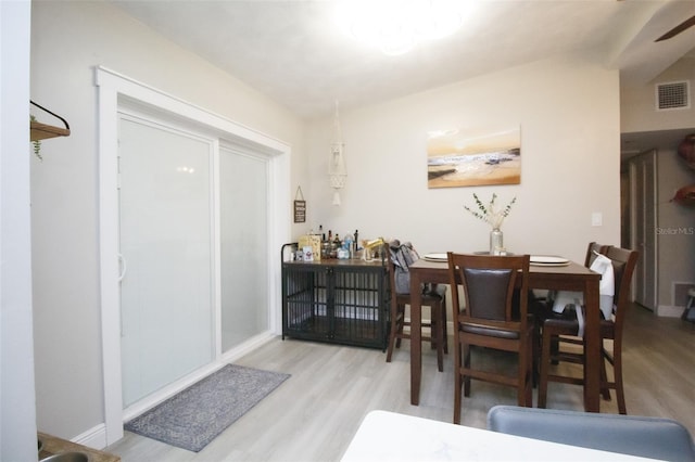 dining space with wood finished floors and baseboards