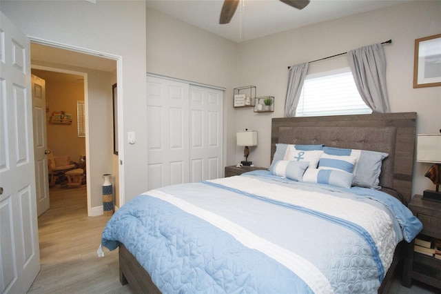 bedroom with light wood finished floors, a closet, a ceiling fan, and baseboards