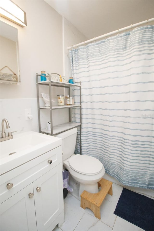 bathroom featuring vanity, toilet, and a shower with curtain