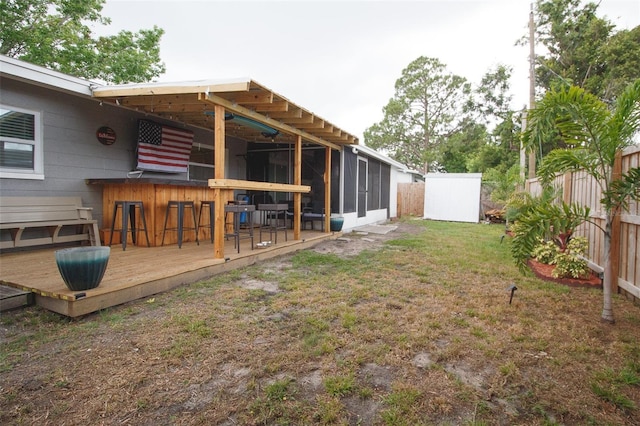 view of yard featuring a wooden deck and a sunroom