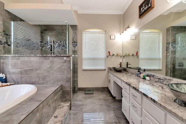 bathroom featuring a stall shower, baseboards, vanity, a garden tub, and ornamental molding