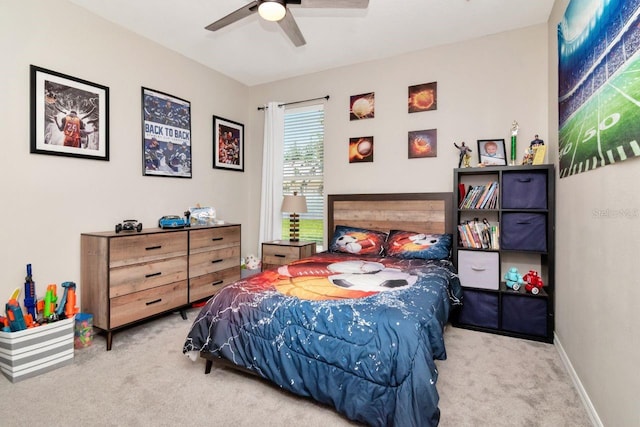 carpeted bedroom featuring a ceiling fan and baseboards