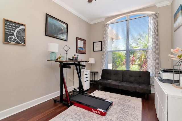workout room with dark wood-style flooring, ornamental molding, baseboards, and a ceiling fan