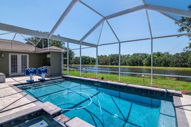 view of swimming pool featuring french doors, a water view, a patio area, and glass enclosure