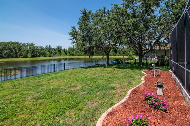 view of yard featuring a water view and a lanai