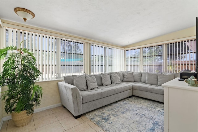 sunroom featuring vaulted ceiling