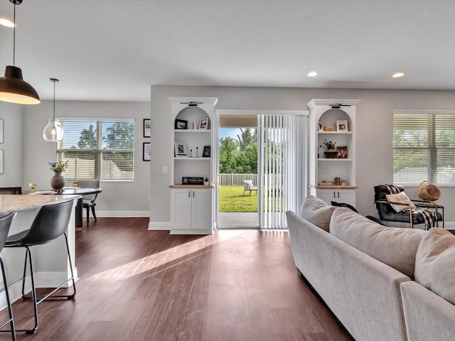 living area with baseboards, dark wood-style floors, and recessed lighting