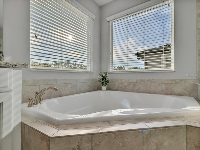 full bath with healthy amount of natural light and a garden tub