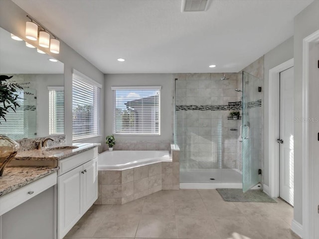bathroom with a stall shower, a bath, tile patterned flooring, vanity, and recessed lighting