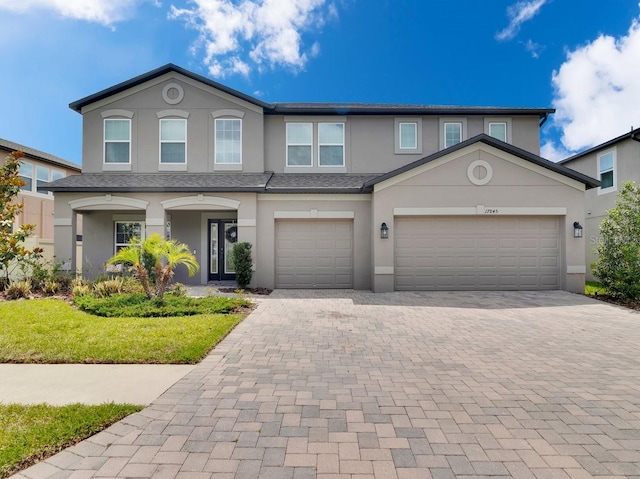 17845 Cortes Creek Blvd, Spring Hill, FL 34610 - view of property featuring decorative driveway and stucco siding