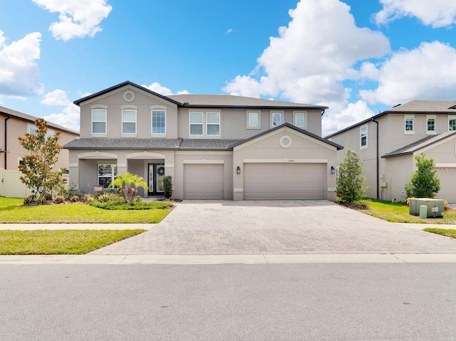 17845 Cortes Creek Blvd, Spring Hill, FL 34610 - view of front of home featuring stucco siding, driveway, a front lawn, and roof with shingles