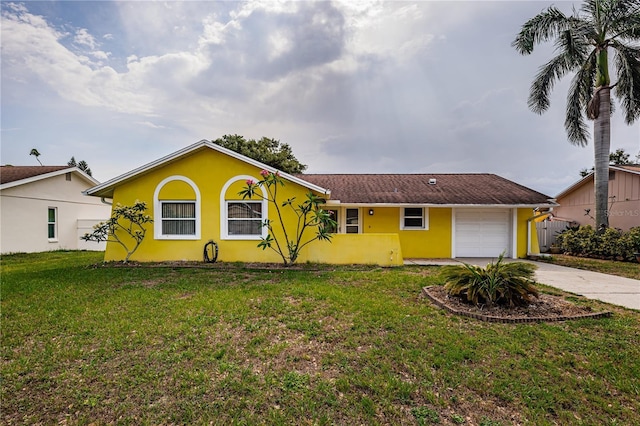 10051 82nd Ln, Seminole, FL 33777 - single story home featuring stucco siding, driveway, a front yard, and a garage
