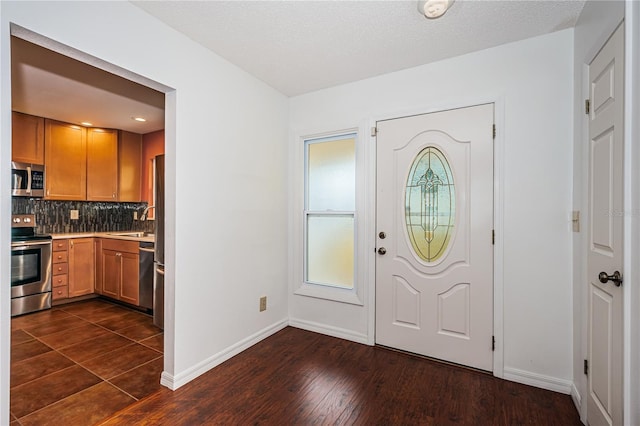 10051 82nd Ln, Seminole, FL 33777 - foyer entrance with baseboards and dark wood-style floors