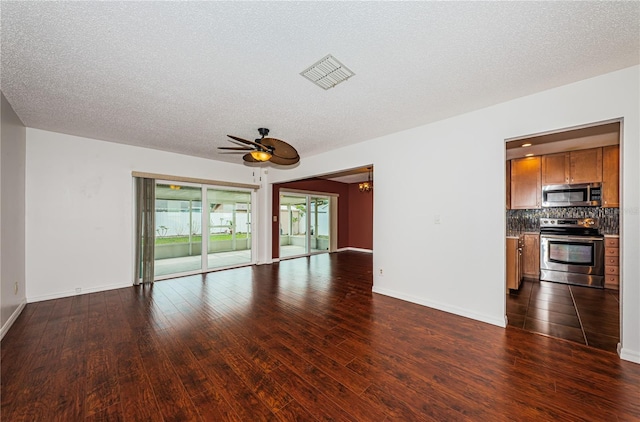 10051 82nd Ln, Seminole, FL 33777 - unfurnished living room featuring ceiling fan, dark wood-type flooring, a textured ceiling, and baseboards