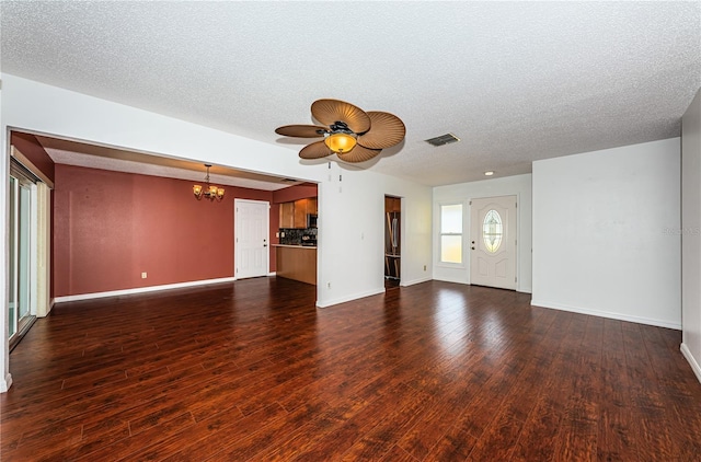 10051 82nd Ln, Seminole, FL 33777 - unfurnished living room with a ceiling fan, a chandelier, baseboards, dark wood-type flooring, and a textured ceiling