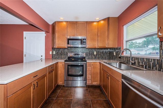 10051 82nd Ln, Seminole, FL 33777 - kitchen with stainless steel appliances, a sink, tasteful backsplash, brown cabinets, and recessed lighting