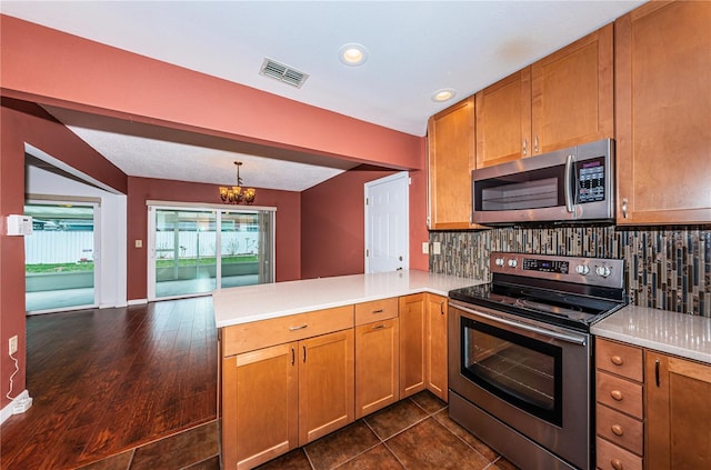 10051 82nd Ln, Seminole, FL 33777 - kitchen featuring appliances with stainless steel finishes, a peninsula, tasteful backsplash, light countertops, and recessed lighting