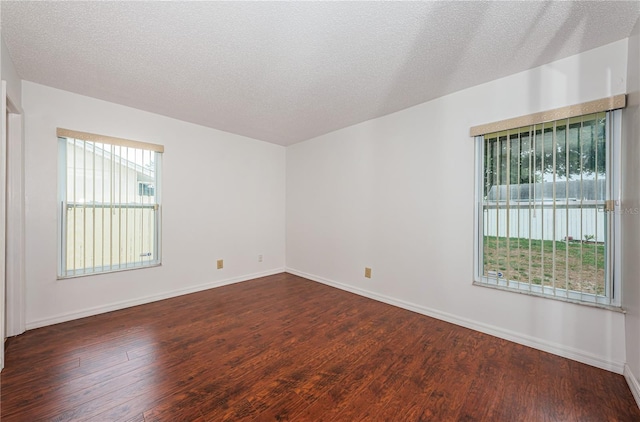 10051 82nd Ln, Seminole, FL 33777 - unfurnished room with dark wood-type flooring, baseboards, and a textured ceiling