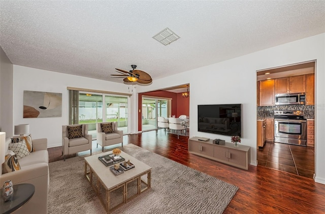10051 82nd Ln, Seminole, FL 33777 - living room featuring a textured ceiling, dark wood-type flooring, and a ceiling fan