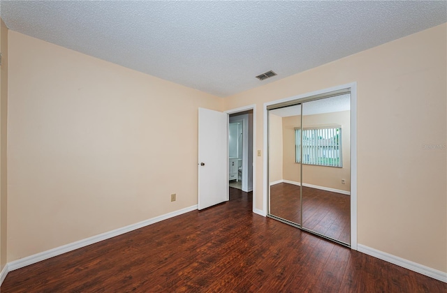 10051 82nd Ln, Seminole, FL 33777 - unfurnished bedroom featuring wood finished floors, a closet, and baseboards